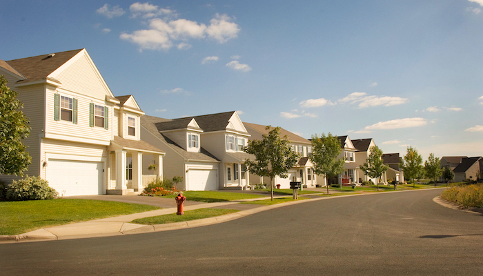 A suburban street full of houses.